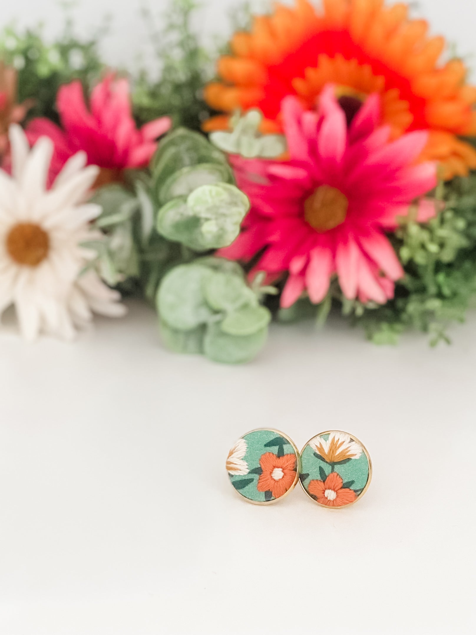 Round clip-on earrings, hand-embroidered